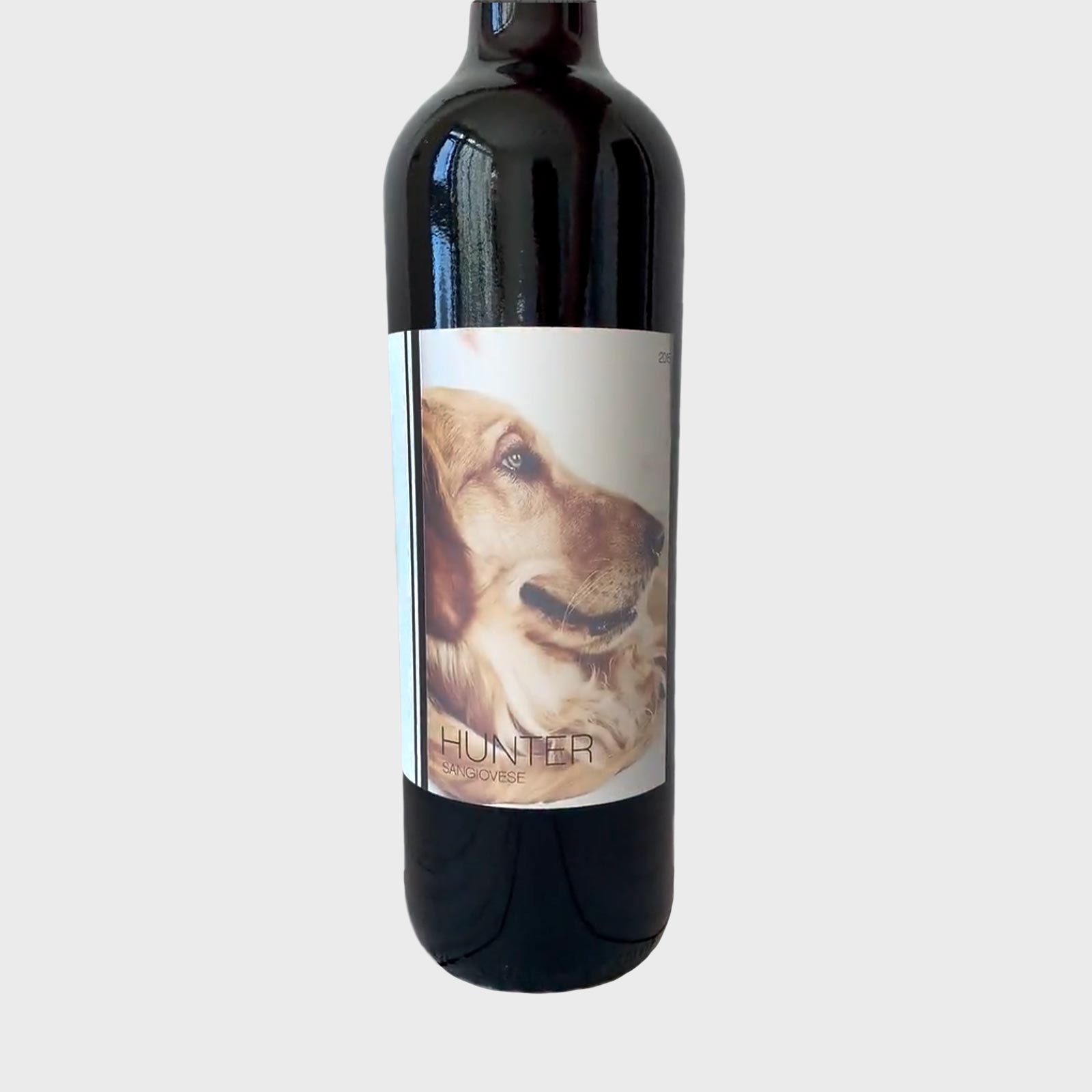 Wine bottle featuring a dog's profile on a label with text: "HUNTER SANGIOVESE," set against a plain background.