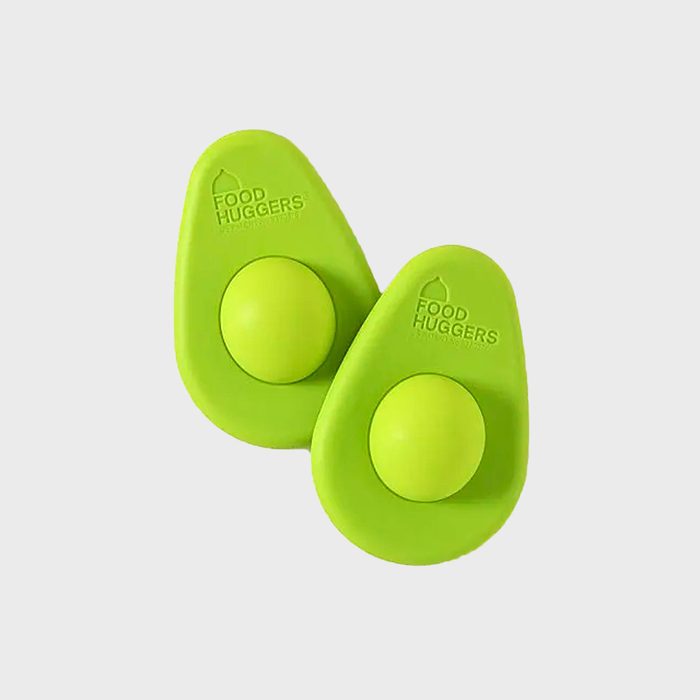 Two green silicone avocado covers rest side-by-side; each features a round center. Text: 