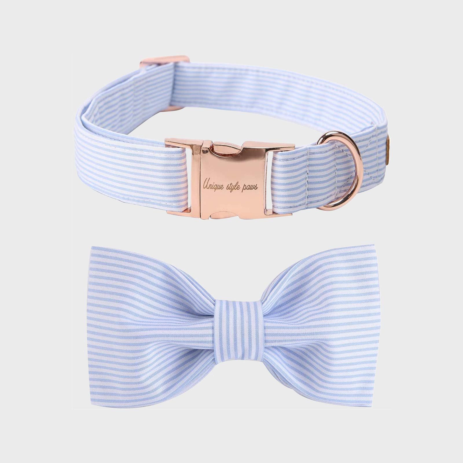 Striped pet collar with bow resting on white background, features rose gold buckle engraved "Unique style paws."