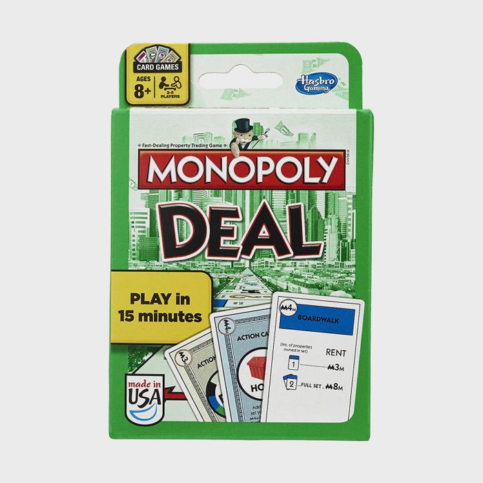 Card game box displaying Monopoly Deal, featuring cityscape background and cards, promotes quick 15 minutes playtime, suitable for ages 8 and up.