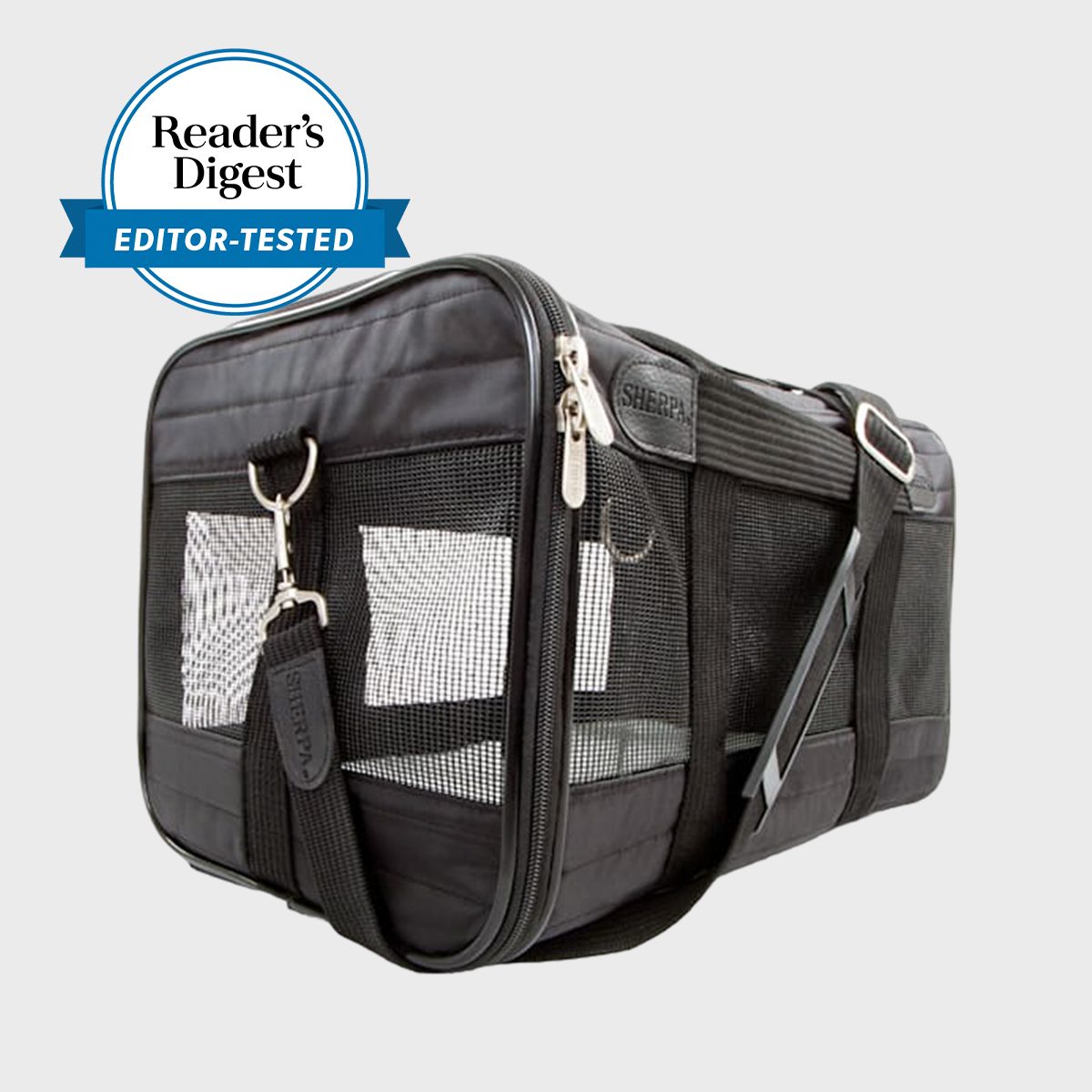 Black pet carrier open on side, featuring mesh ventilation and zipper closures, with shoulder strap in neutral setting. Label: "Reader's Digest Editor-Tested."