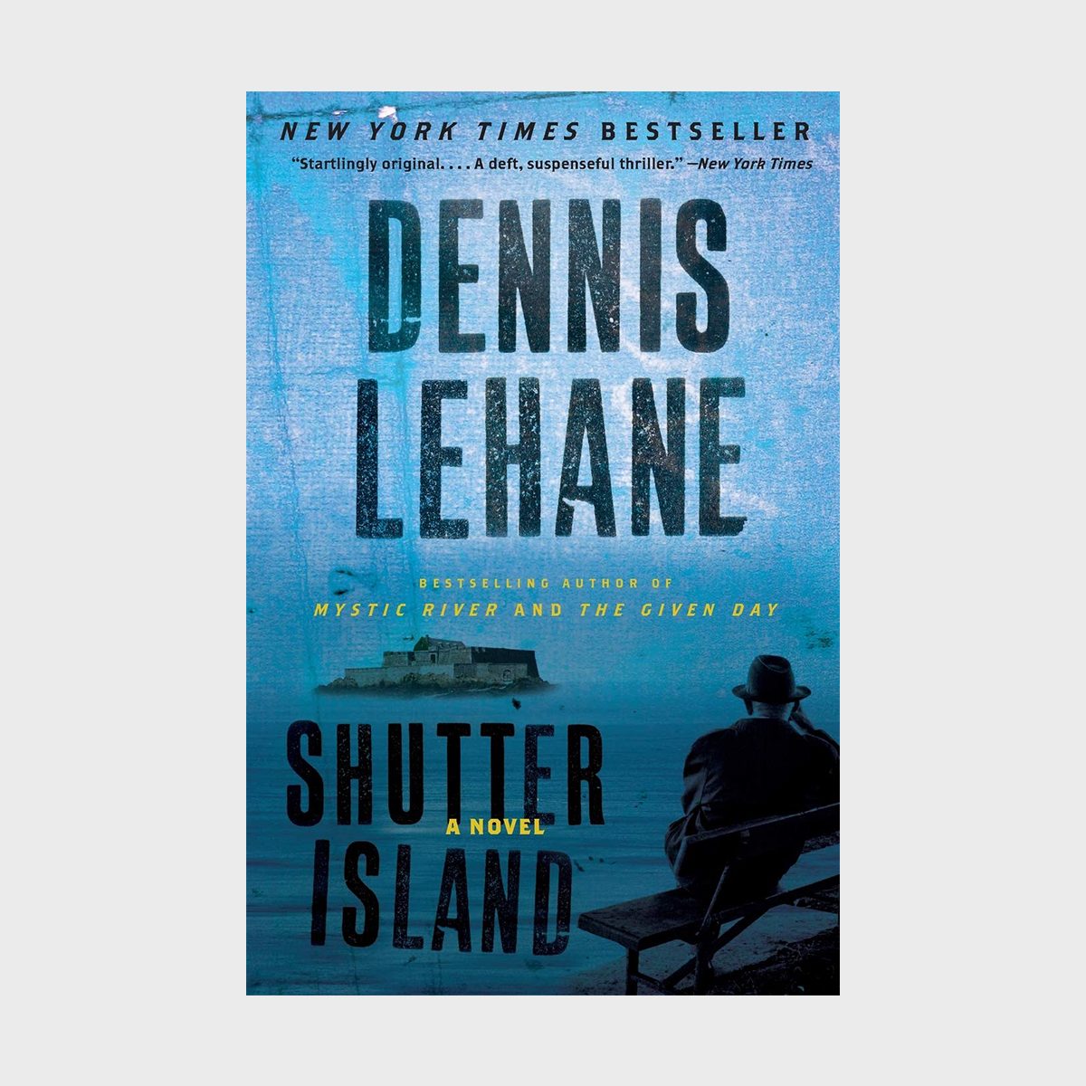 Book cover depicting a seated figure facing an island; text reads "Dennis Lehane, Shutter Island: A Novel," highlighting a New York Times Bestseller.