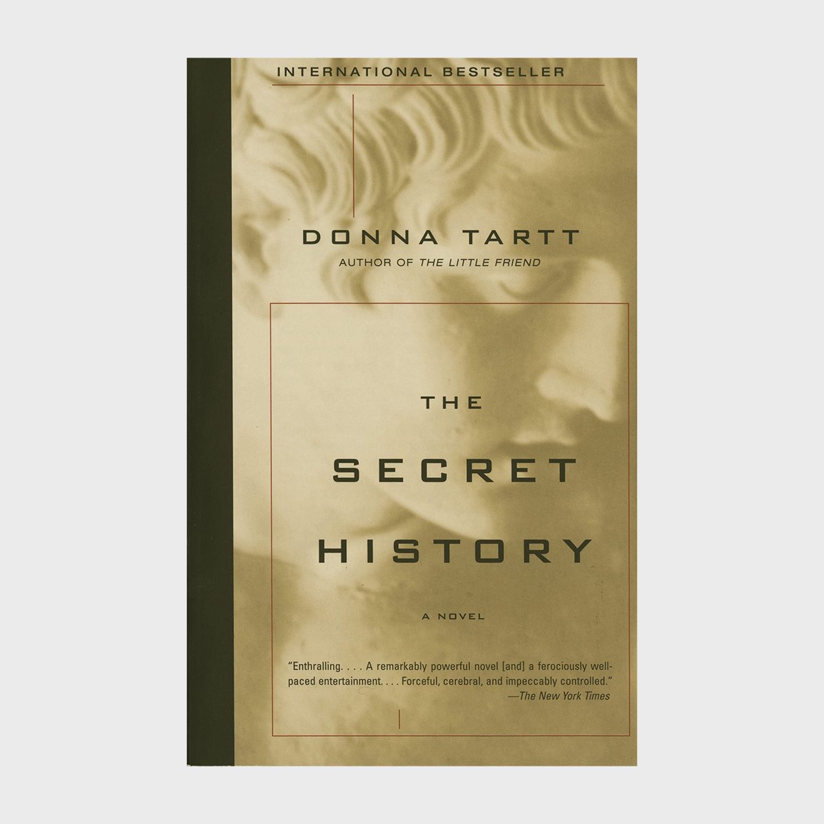 Book cover displaying "The Secret History" by Donna Tartt, featuring a classical sculpture in soft tones, framed by a quote from The New York Times.