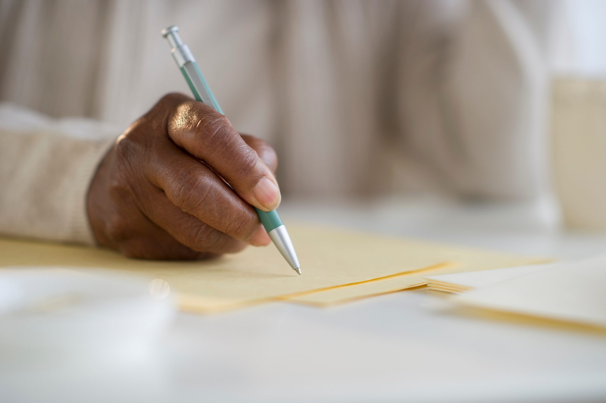 anonymous woman writing a letter