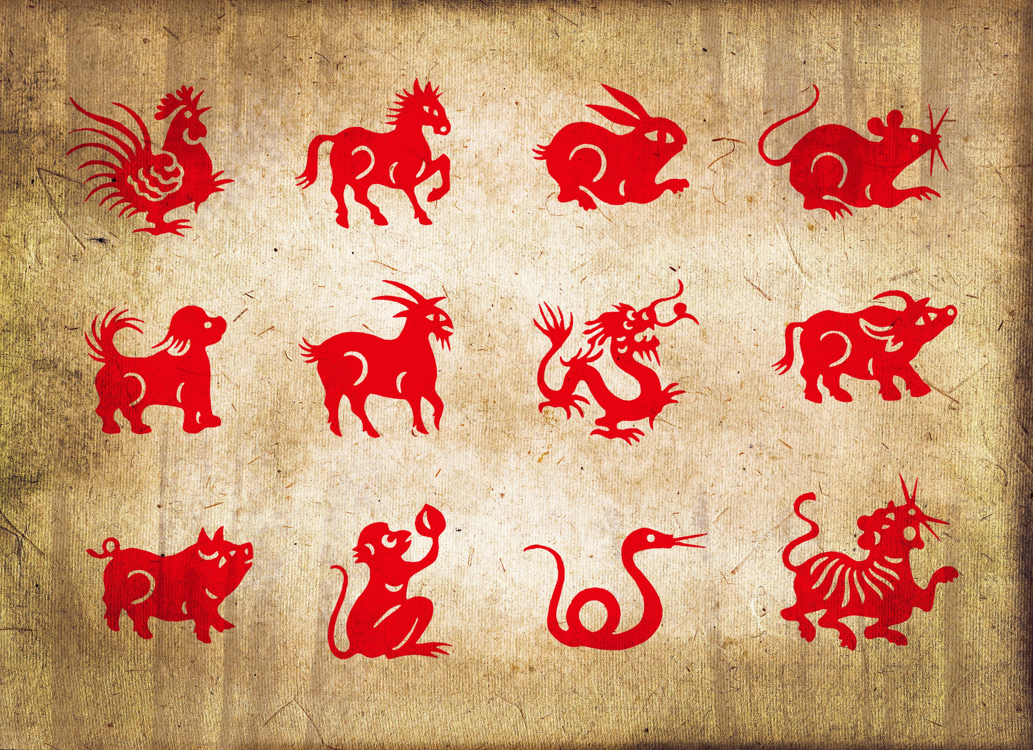 Twelve red animal silhouettes include a rooster, horse, rabbit, rat, dog, goat, dragon, ox, pig, monkey, snake, and tiger on textured background.