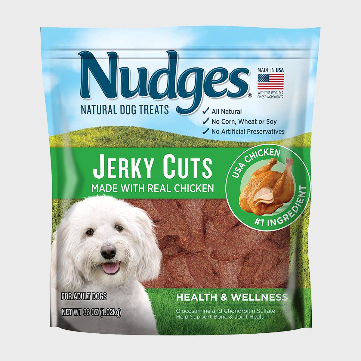 Dog treat package displays "Nudges Jerky Cuts" with a white dog, emphasizing natural ingredients and chicken, promoting health and wellness benefits.