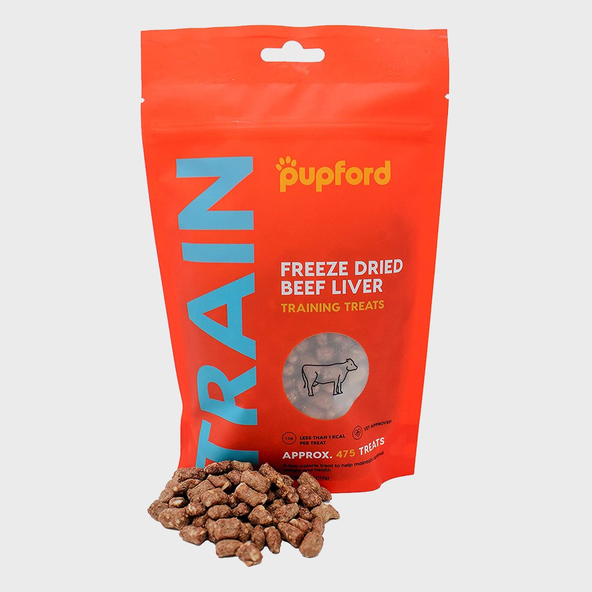 Pouch displays "Freeze Dried Beef Liver Training Treats"; treats spill onto surface; bright red packaging with blue text in clean design.
