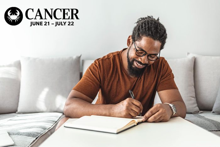 a man writing in a journal