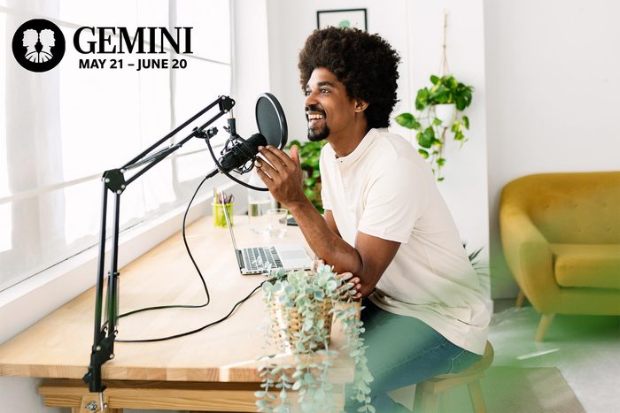 a man talking into a microphone for his podcast