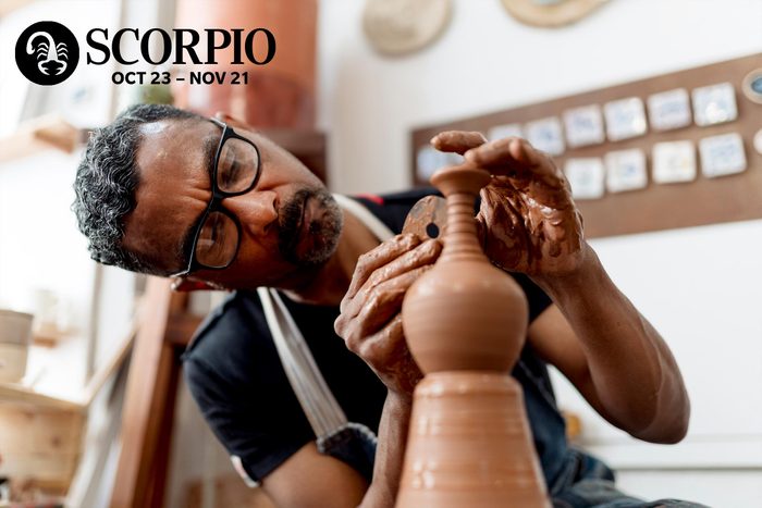 a man working with clay on a wheel