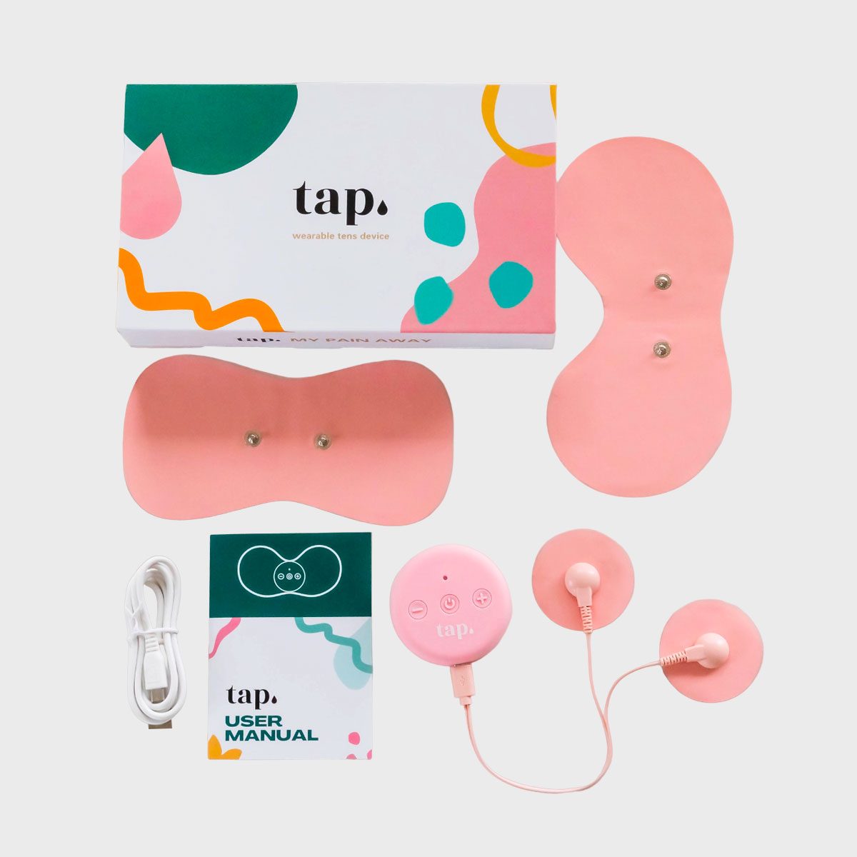 TENS device components arranged neatly; box, pink electrodes, controller, manual, and charging cable; set against a plain background. Box text: "tap. wearable tens device."