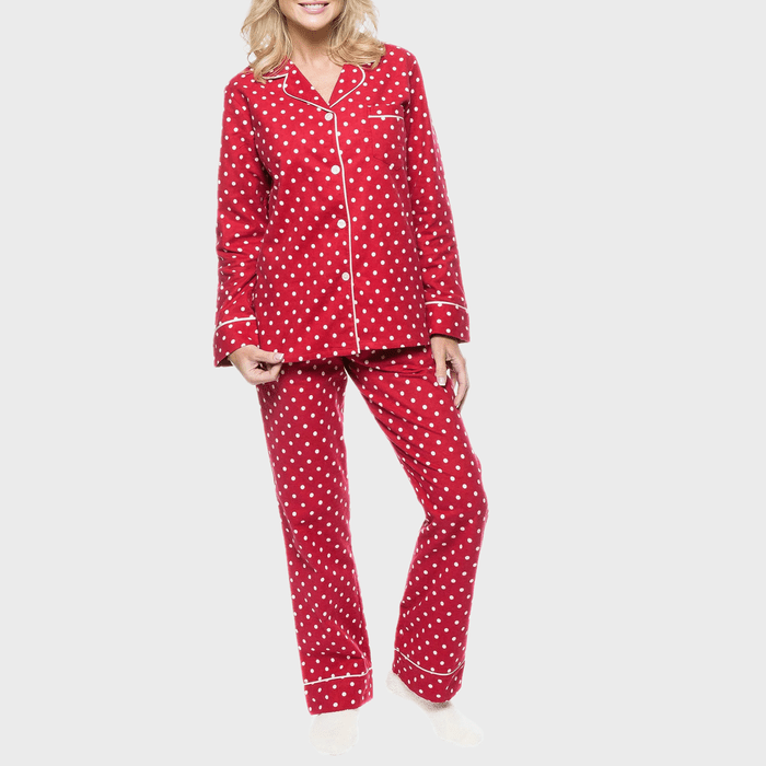 Person wearing red, polka dot pajamas, standing against a plain white background.