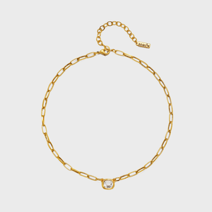 Gold chain necklace centered with a square-shaped gem, placed on a plain white background. Tag reads 