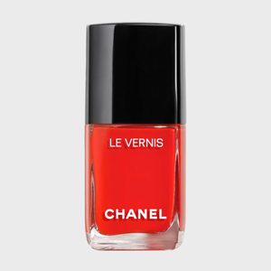 A bottle of red nail polish labeled 