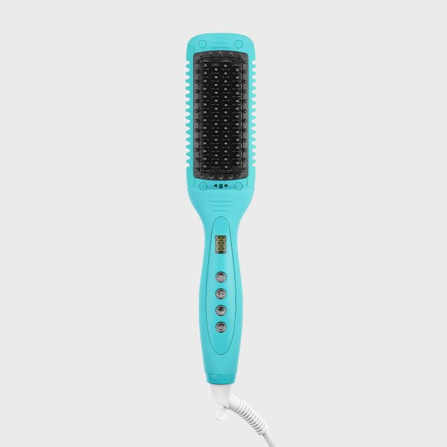 Turquoise electric hairbrush displays temperature settings; buttons and a digital screen are visible. The device rests against a plain white background.