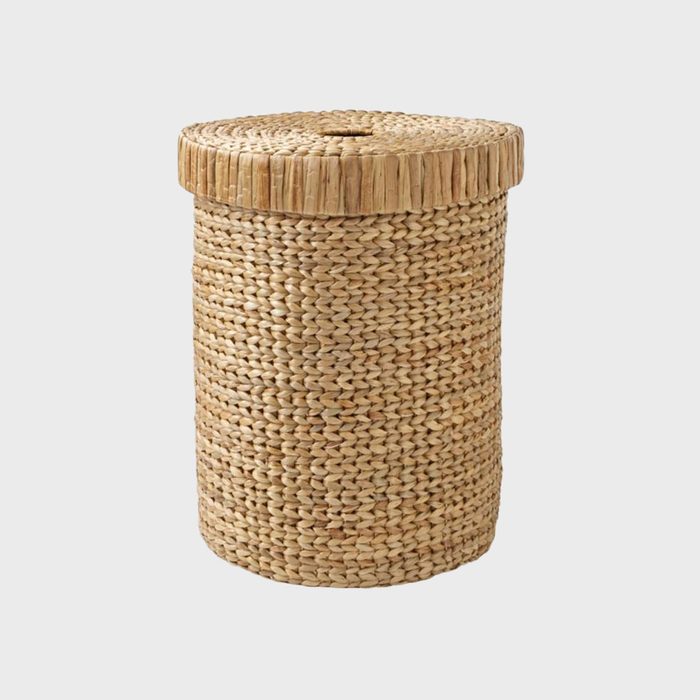 A woven basket with a lid stands upright against a plain white background.