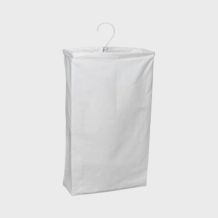 A white garment bag hangs against a plain background, featuring a metal hook on top for hanging clothes.