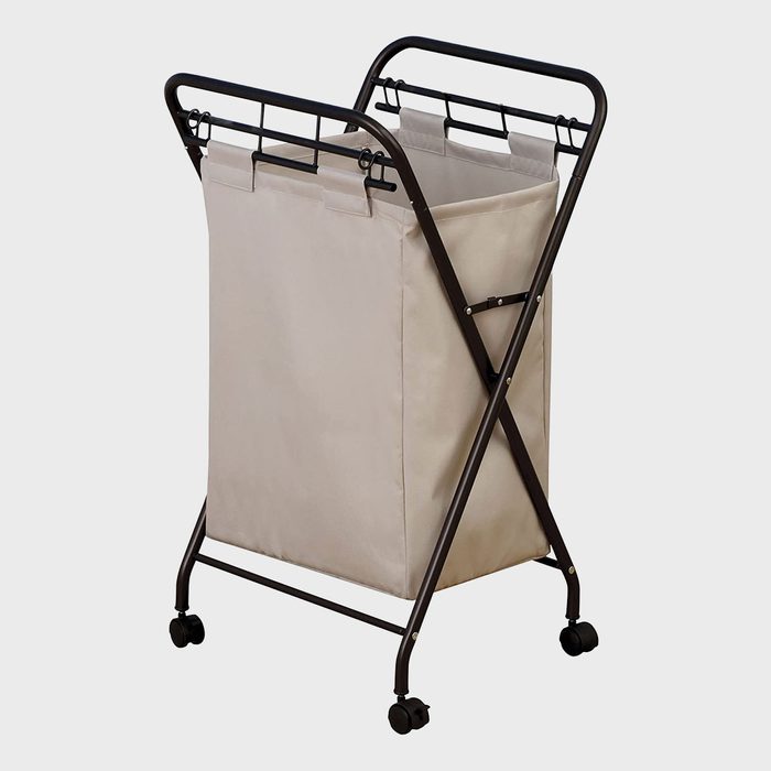 Laundry basket on wheels, standing upright, with a beige fabric bag and black metal frame, set against a plain white background.
