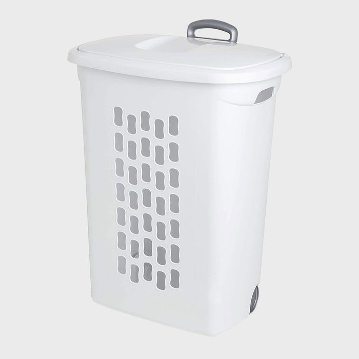 White laundry hamper with lid and handle, featuring ventilation holes, stands in a bright, neutral background.