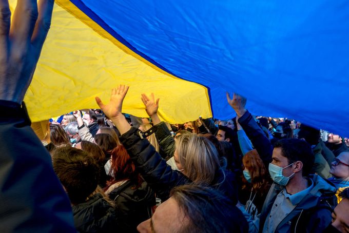 Dozens of people raise a Ukrainian national flag in their hands during a demonstration in support of the Ukrainian people on March 02, 2022 in Brussels, Belgium.