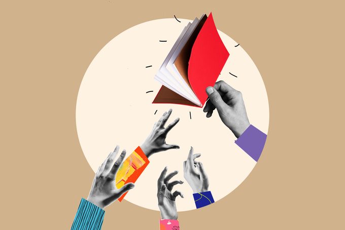 hands reaching for books in a circle