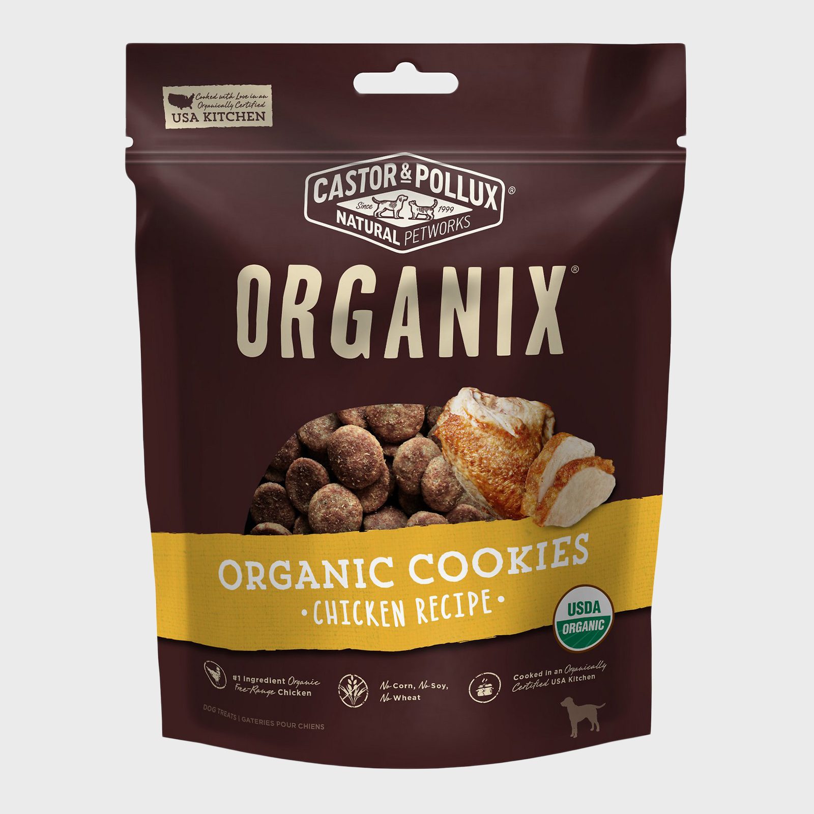 Bag of "Organix" organic chicken dog cookies, showing brown treats and chicken, with USDA Organic label and nutritional claims, set against a plain background.