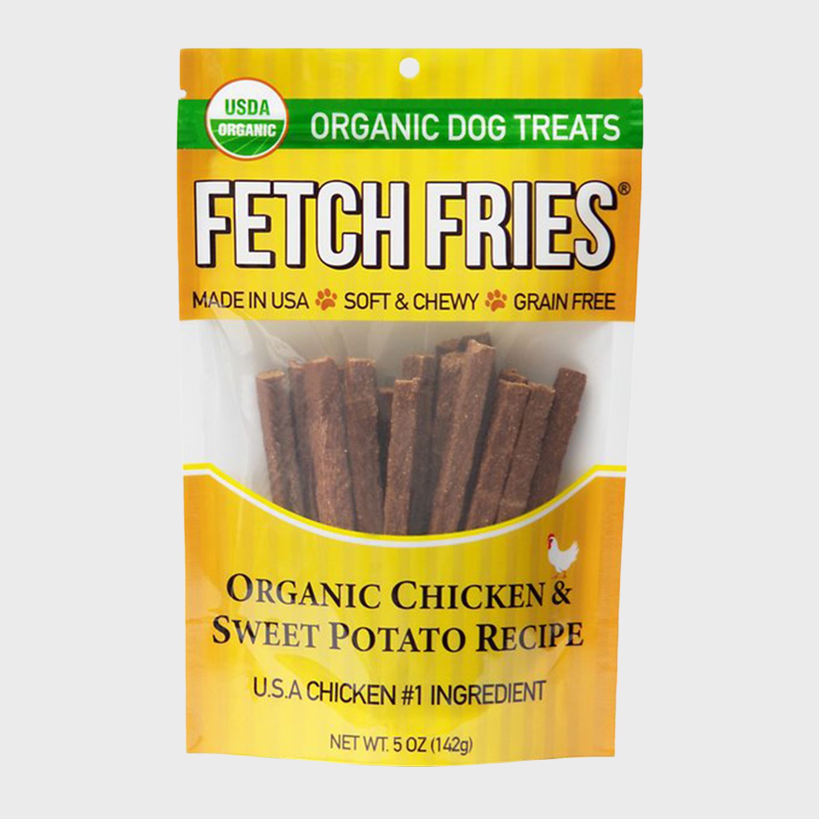 Dog treats packaged in a yellow bag marked "Fetch Fries," featuring organic chicken and sweet potato recipe, USDA organic certification, Made in USA.
