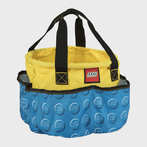 Bag displays LEGO logo, featuring yellow top, blue base with LEGO patterns, black handles; suitable for carrying, set against plain background.