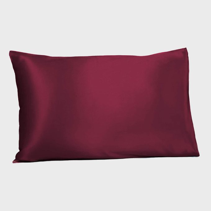 A burgundy pillowcase lies flat on a plain white background.