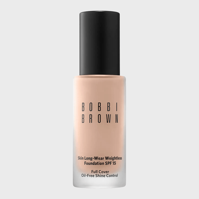 A foundation bottle stands upright, displaying text: 