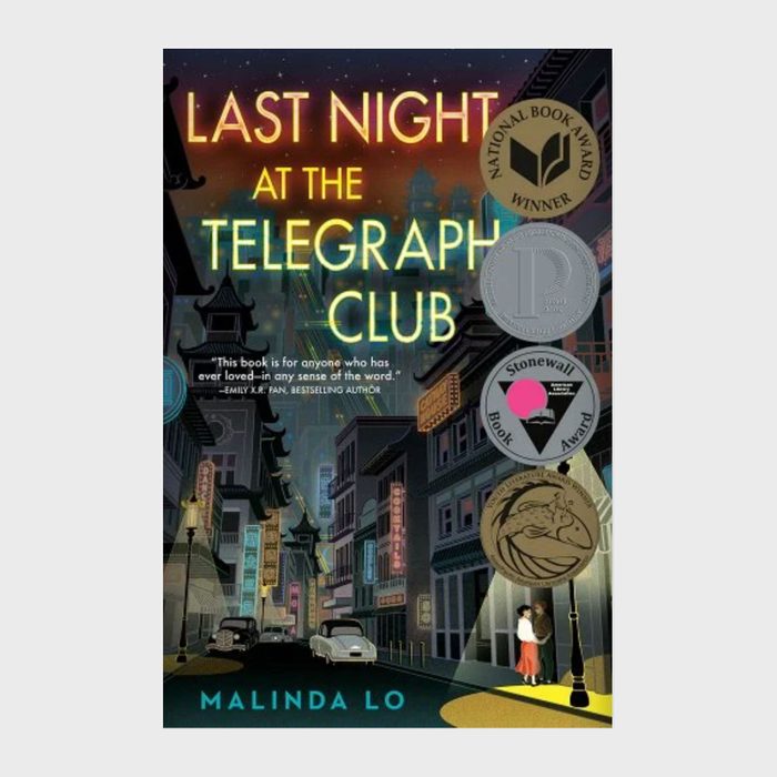 Book cover shows two people embracing under streetlights in a vintage city. Title: 