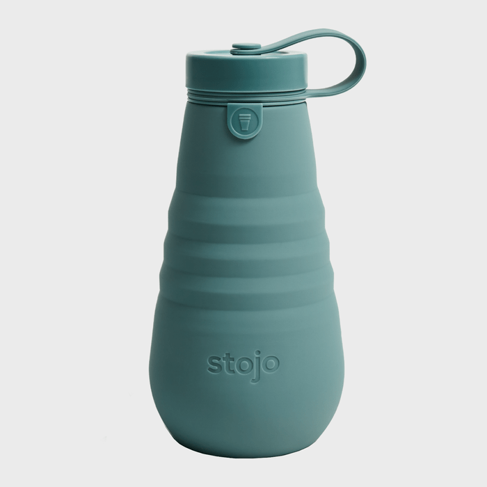 A teal collapsible water bottle stands upright on a plain background, with the brand 