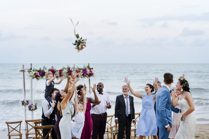Bride throwing the bouquet at wedding