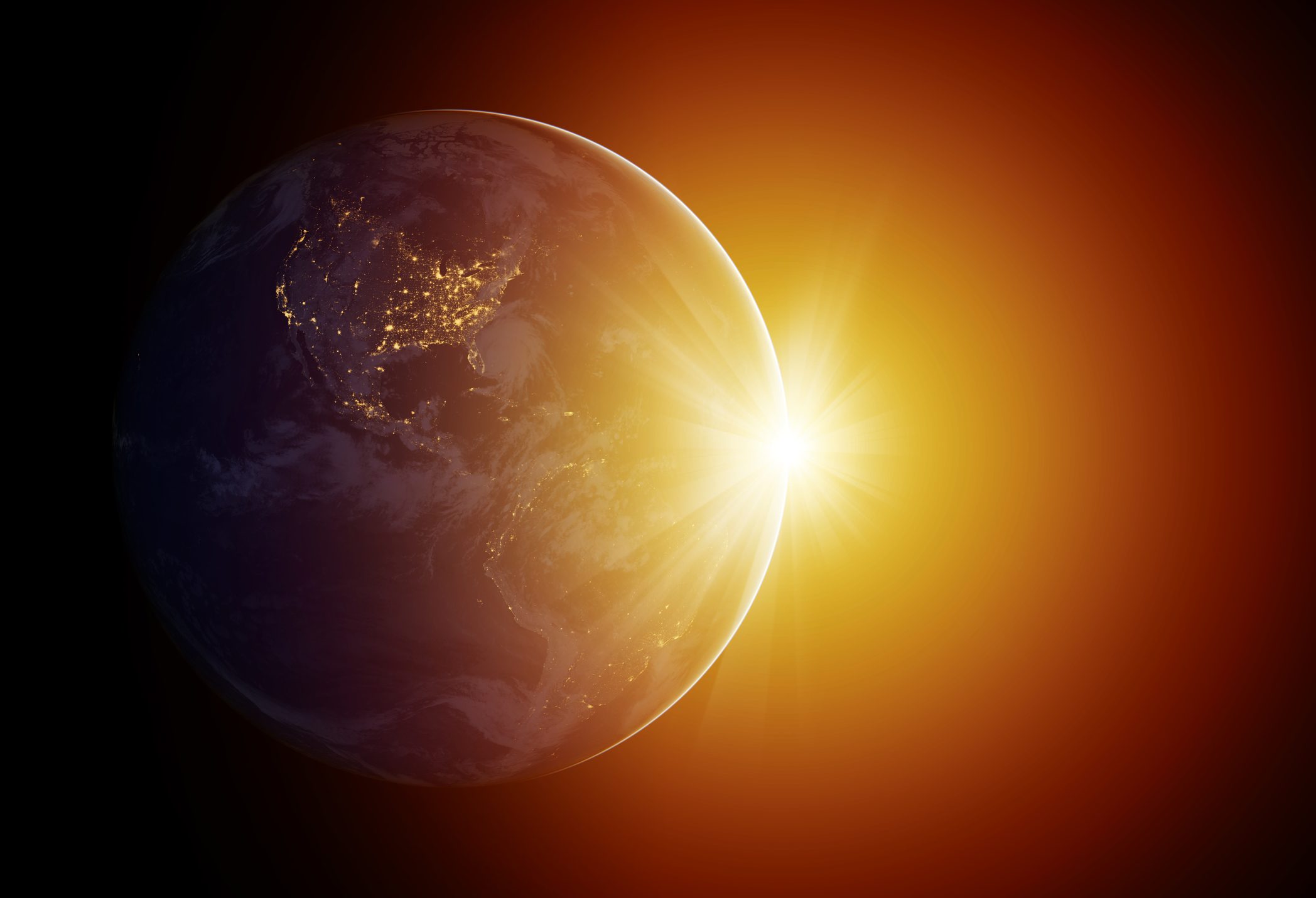 Earth partially illuminated by sunlight, showing lit-up cities at night, against a glowing, orange space backdrop.