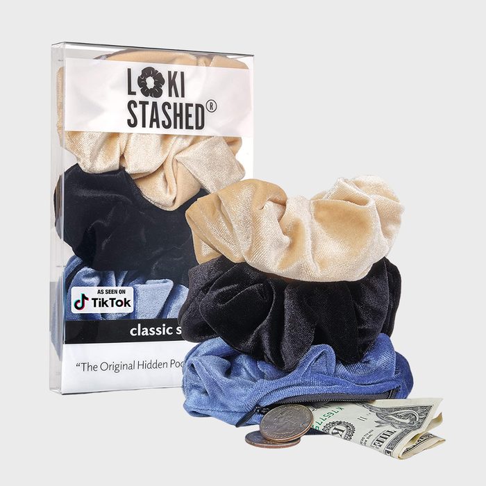 Scrunchies hold coins and a dollar bill; displayed in transparent packaging labeled 
