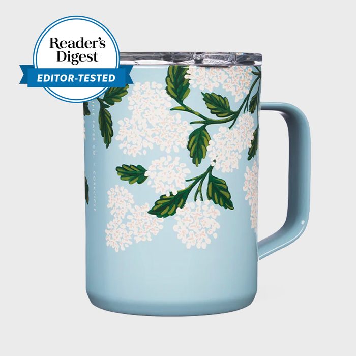 A floral-patterned mug with a handle rests against a plain background. A 