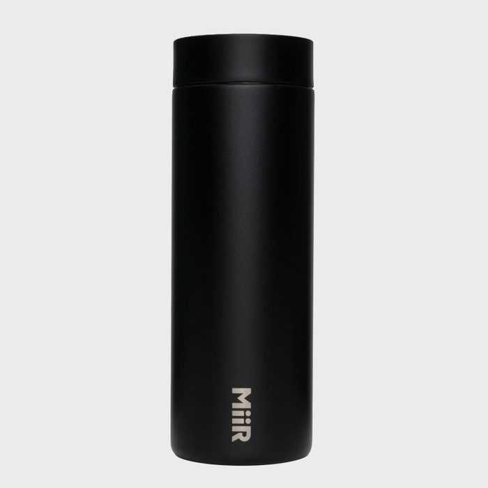 Black travel mug standing upright, featuring the brand 