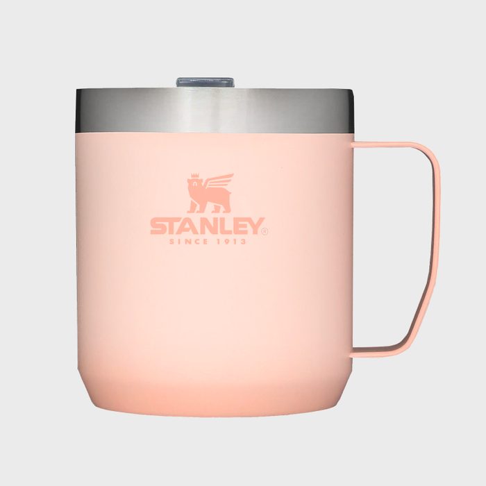 A pink mug with a handle sits, featuring 