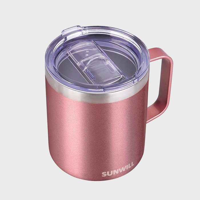 A pink insulated mug with a clear lid sits on a plain background. The word 