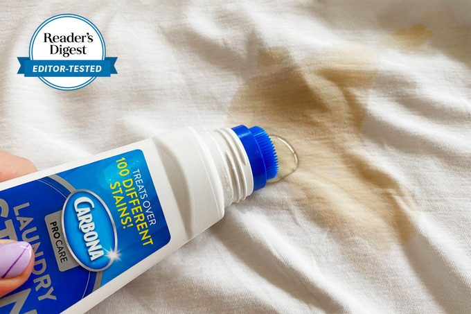 Carbona Stain Remover being used on a stained white sheet with the Reader's digest editor tested logo