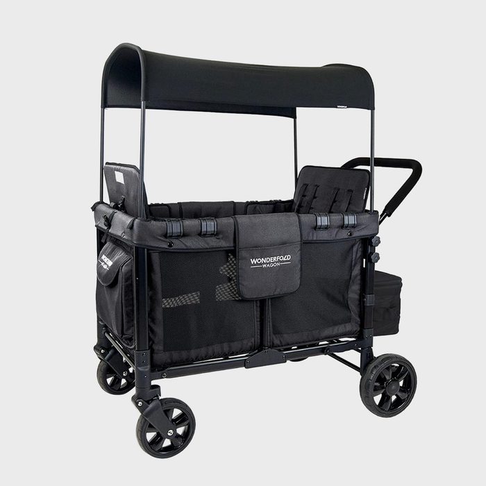 A black stroller wagon with canopy and mesh sides stands stationary, featuring four wheels and labeled 