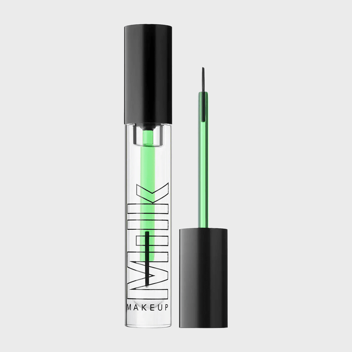 Clear tube with green eyeliner inside and brush, labeled 