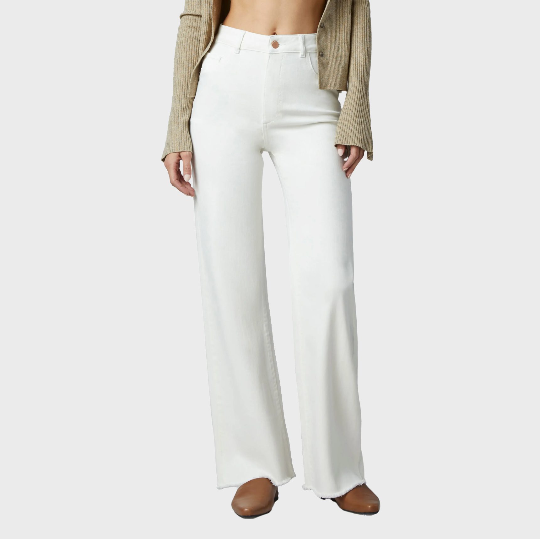 White wide-leg pants worn by a standing person, paired with a cropped beige sweater and brown shoes on a plain gray background.