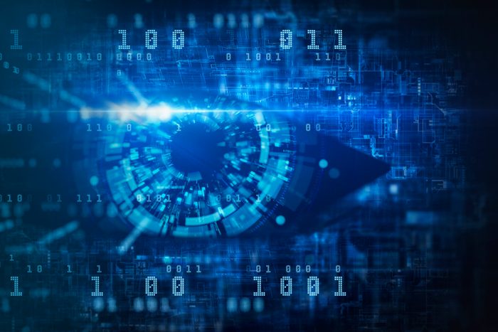 Abstract circuit and mechanical eye on dark background. Digital internet crime illustration