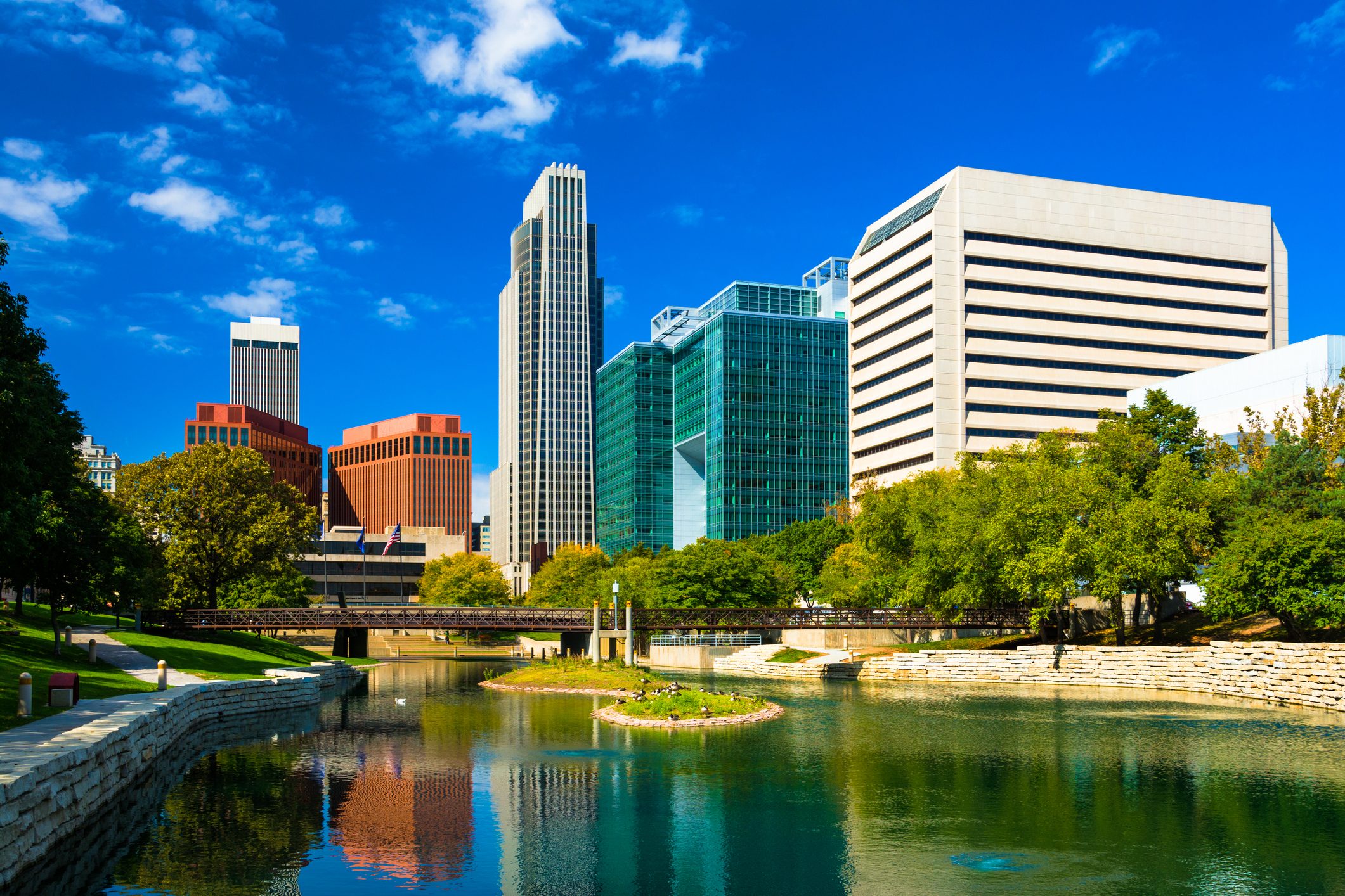 downtown Omaha nebraska Skyline with Gene Leahy Mall and a reflective waterway in the foreground