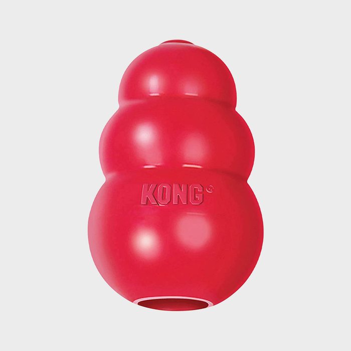 Red rubber toy stands upright against plain white background, featuring the word 