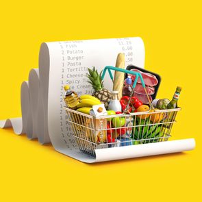 A shopping basket holds groceries, including bread, fruits, and meats, placed on a large printed receipt, against a bright yellow background.