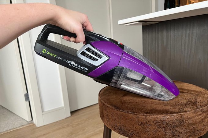 using the Bissell Pet Hair Remover on a bar stool