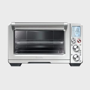 Toaster oven displaying digital settings, buttons, and dials; positioned in a straightforward manner against a plain background.