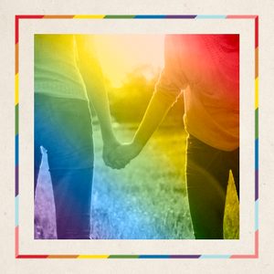 Two people holding hands, walking in a sunlit grassy field, framed with a colorful rainbow border.